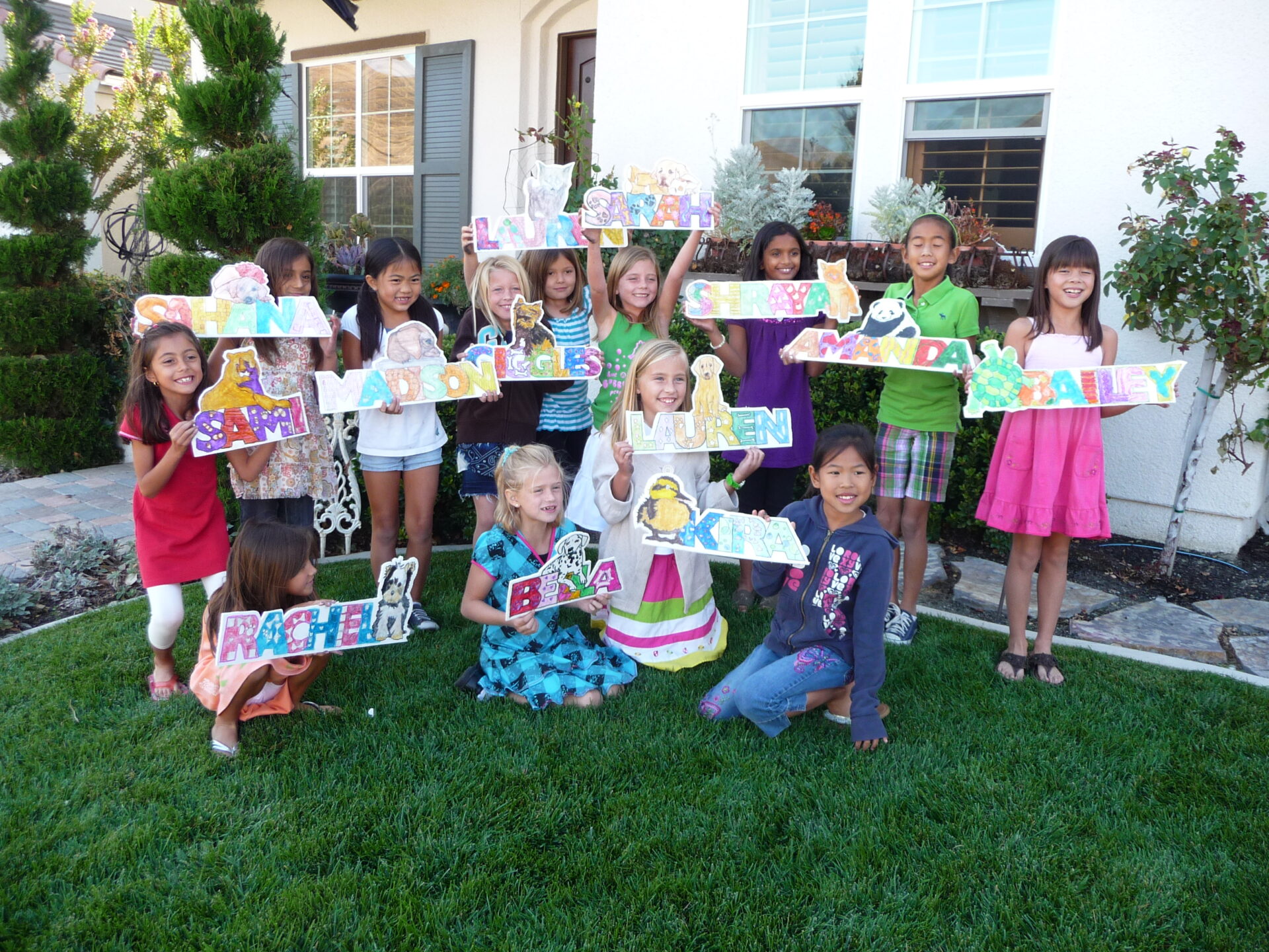 A group of children showing their finished paintings