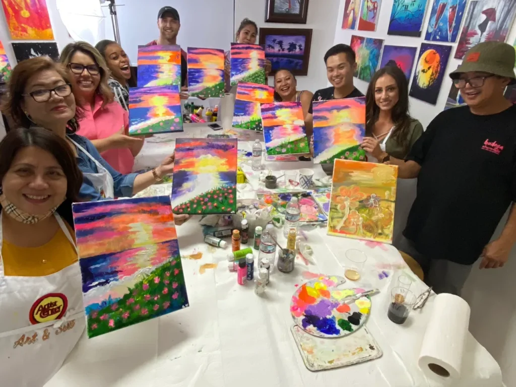 People with colorful paintings holding in hand and smiling