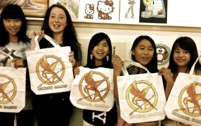 Five children showing customized tote bags