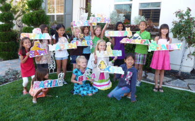 A group of children showing their finished paintings